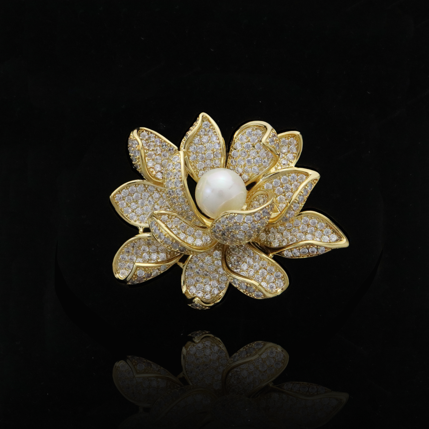 Gleaming gold lotus brooch with diamond pavé petals and a central pearl