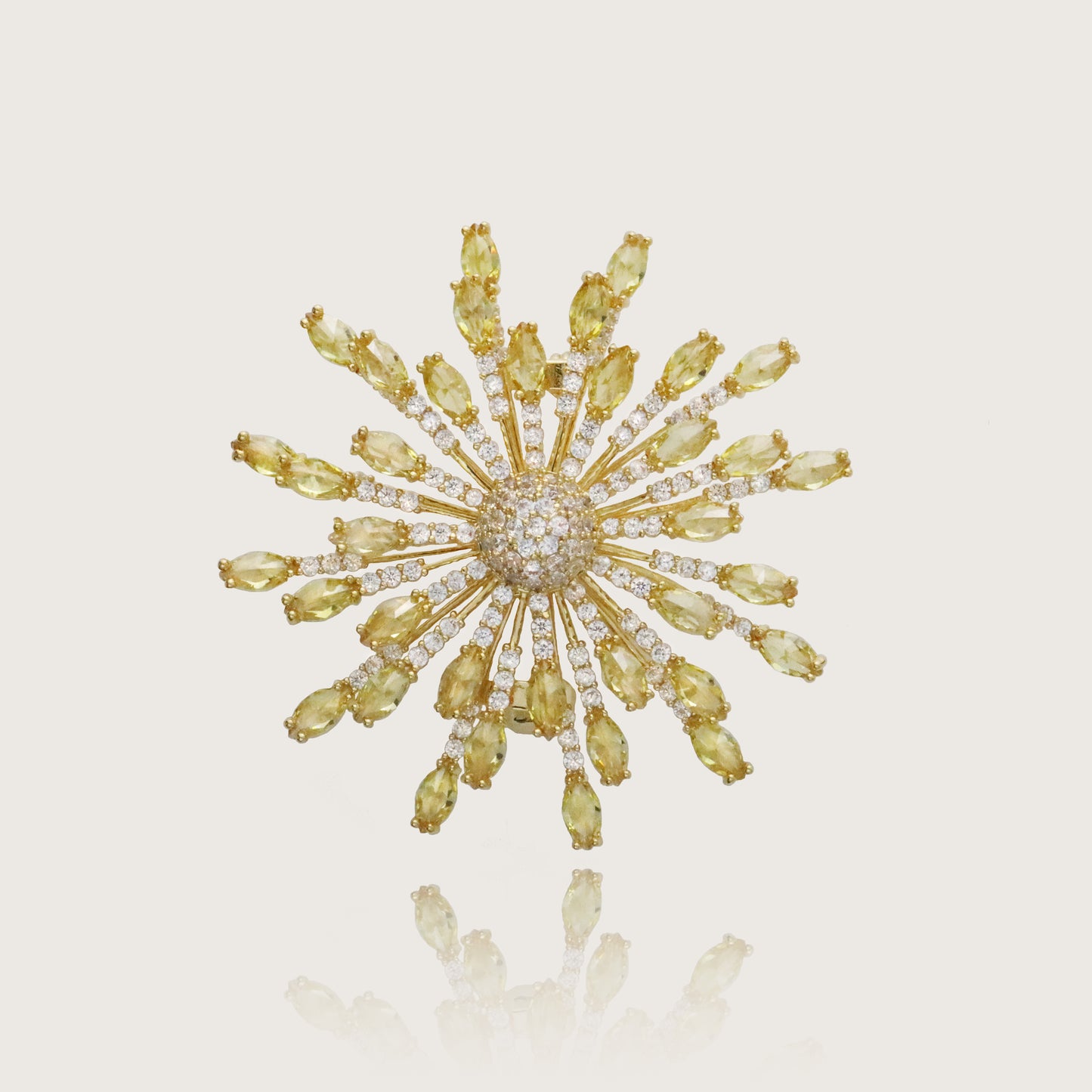 Glimmering golden sunflower brooch with crystal embellishments and a central pavé.