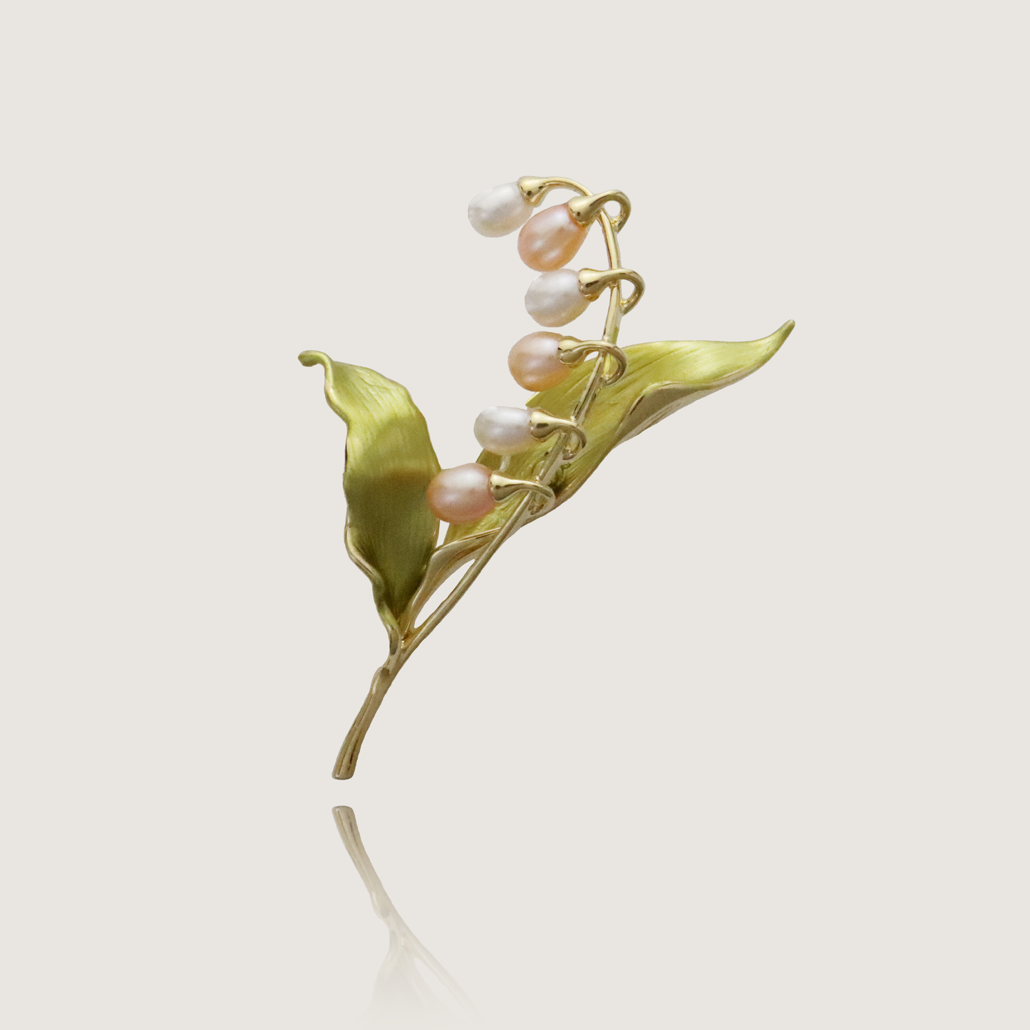 Graceful gold botanical pin featuring a cascade of delicate pearls