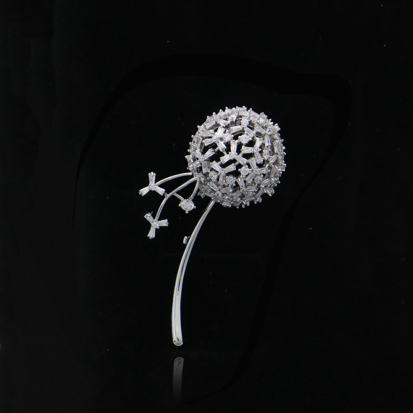 Contemporary dandelion-inspired brooch with sparkling accents.