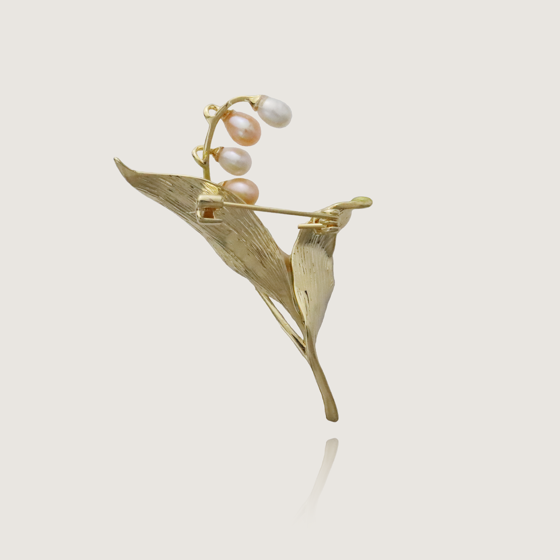 Artisan gold and pearl lily of the valley brooch, symbolizing return to happiness