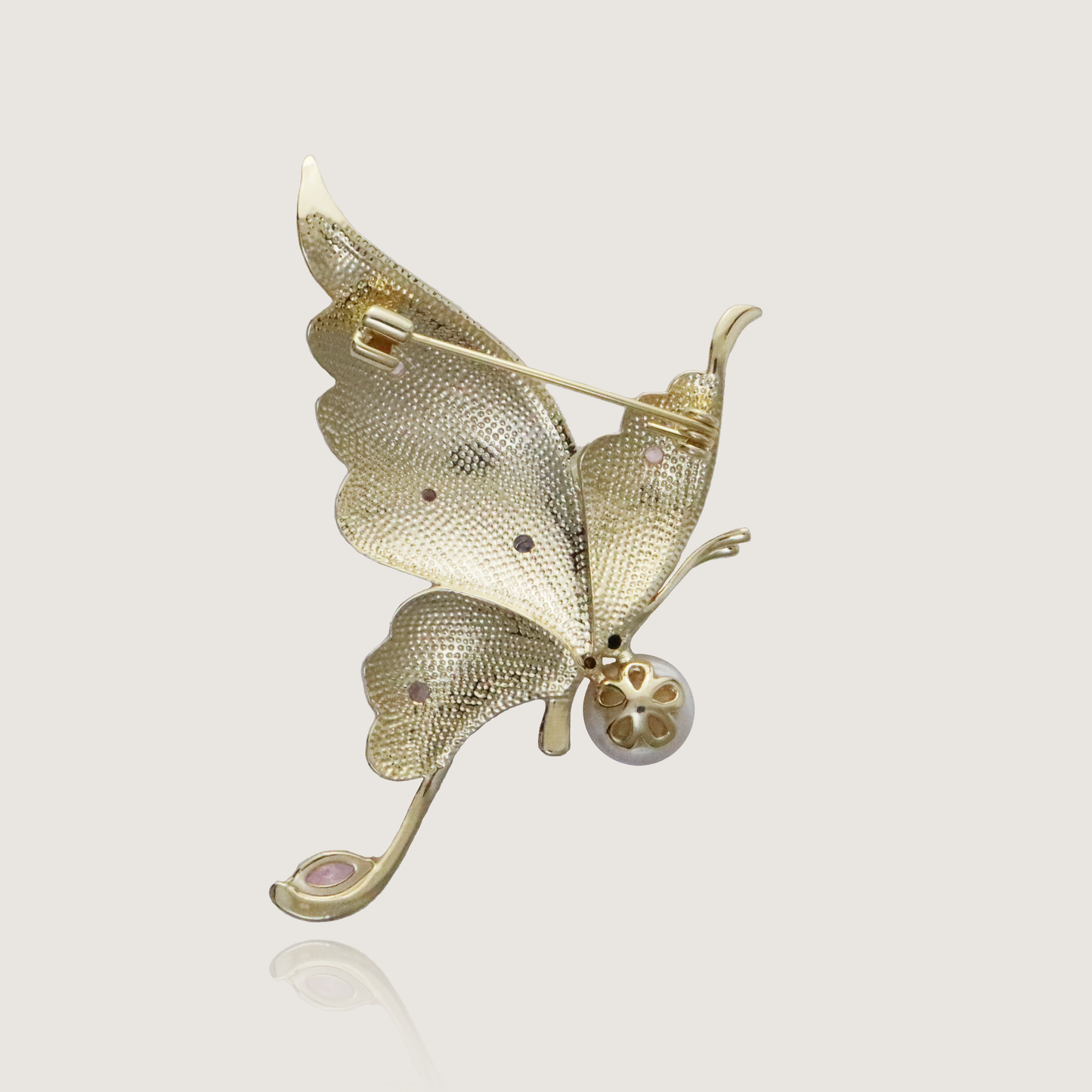 Artistic butterfly brooch in soft hues with a lustrous pearl and gem embellishments