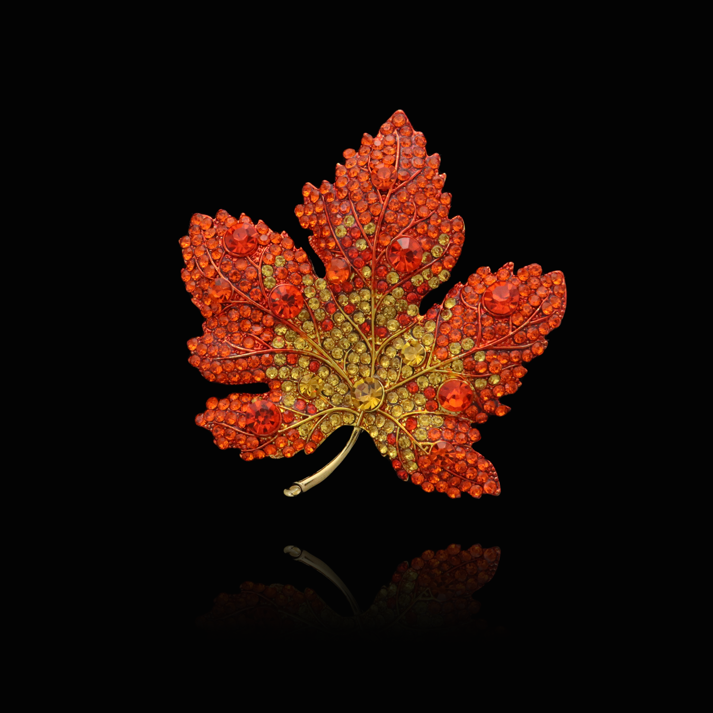 Autumn-inspired ruby maple leaf pin with golden veins