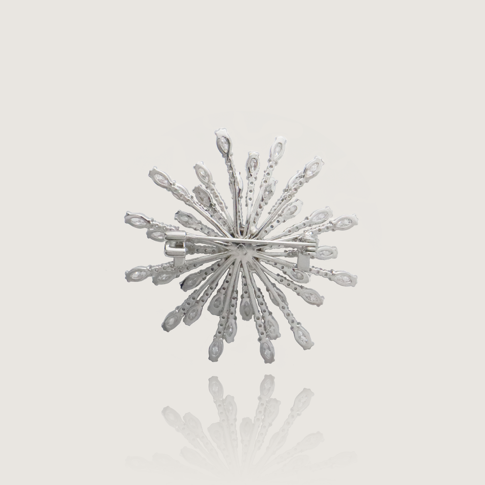 Dazzling silver starburst pin with crystalline rays and pavé core