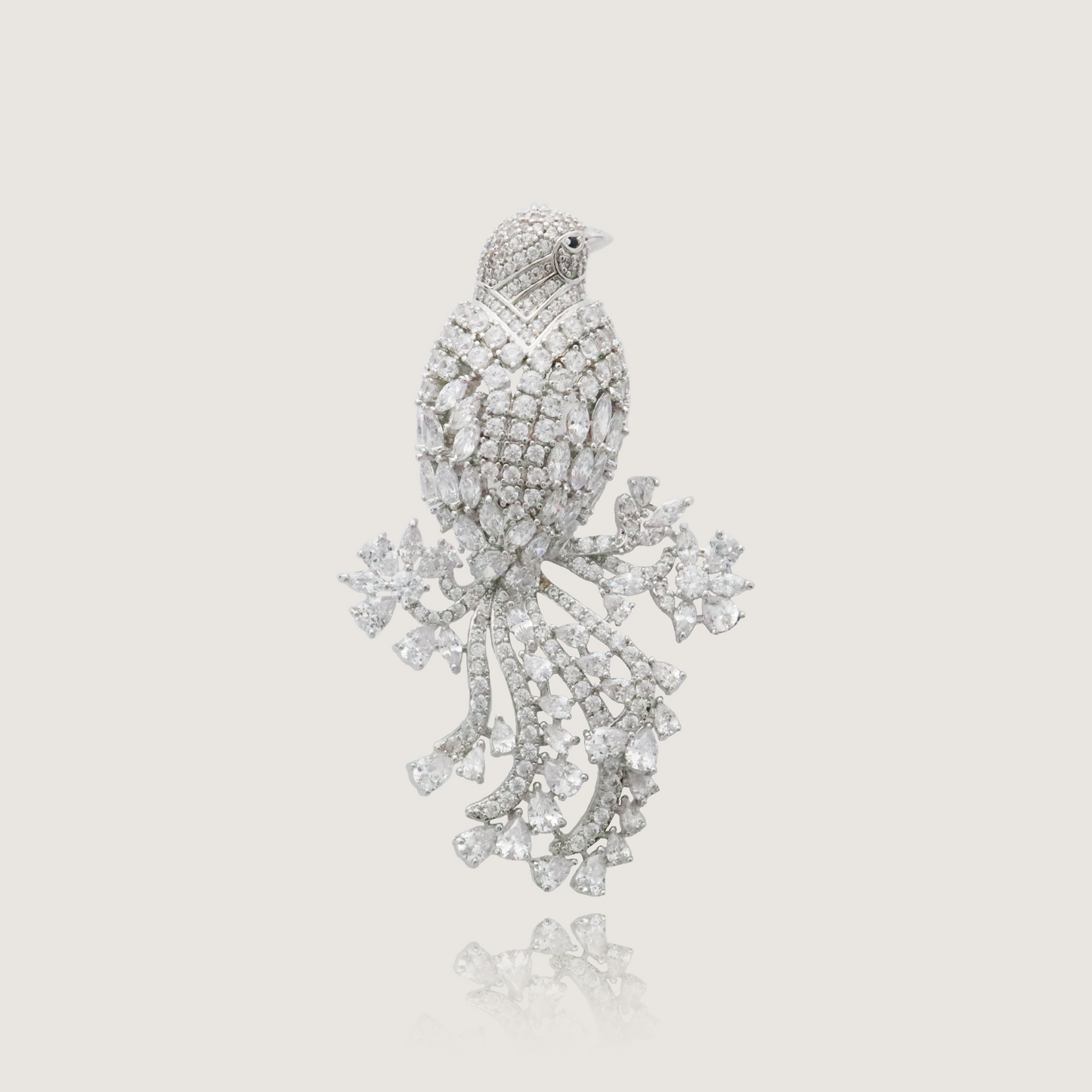 Elegant crystalline bird brooch with a cascade of shimmering tail feathers.