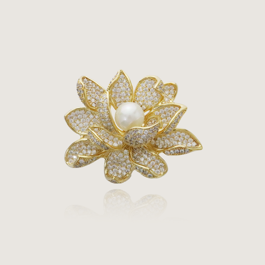 Elegant floral pin adorned with diamonds and a lustrous pearl in gold setting