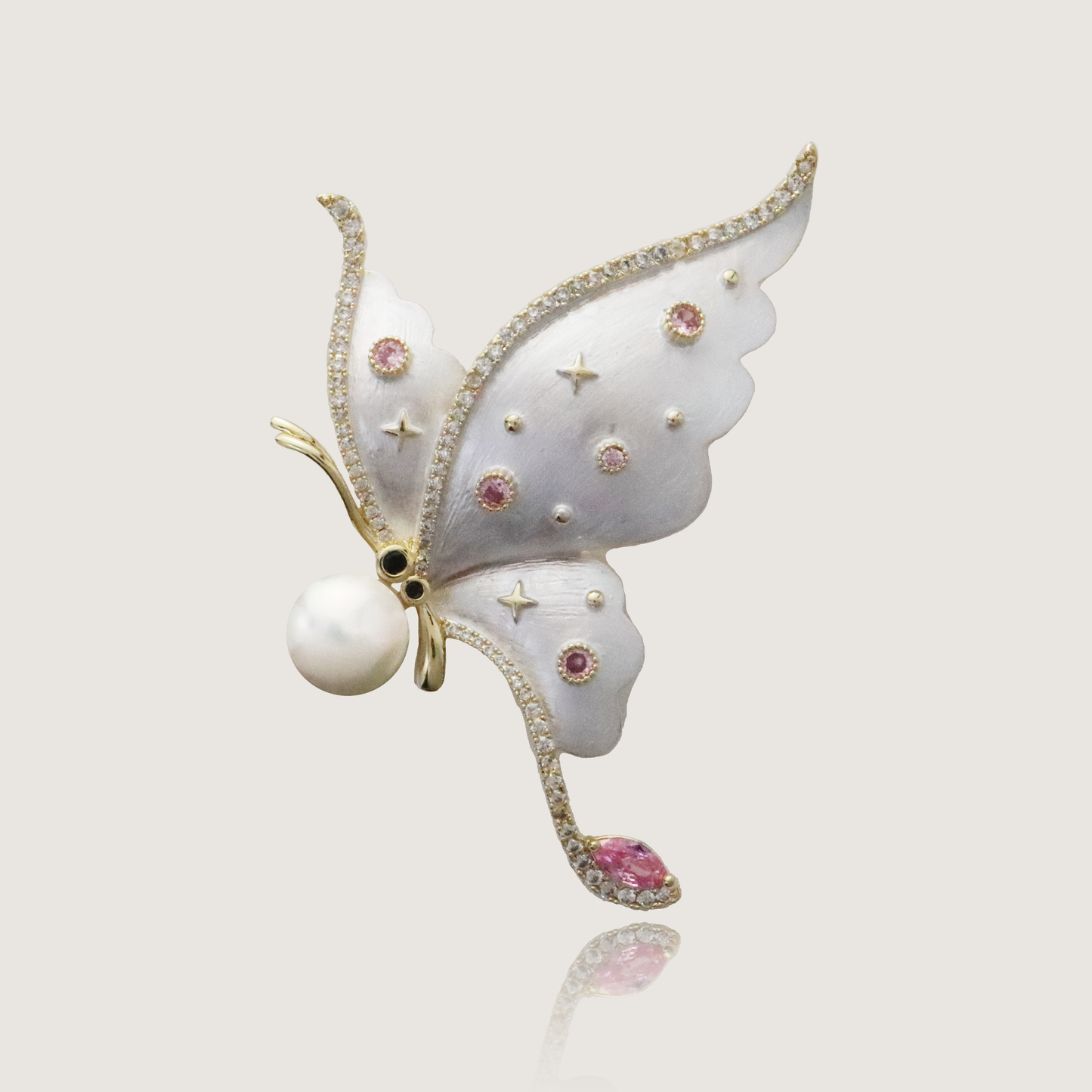 Ethereal butterfly brooch with delicate pink gemstones and a central pearl