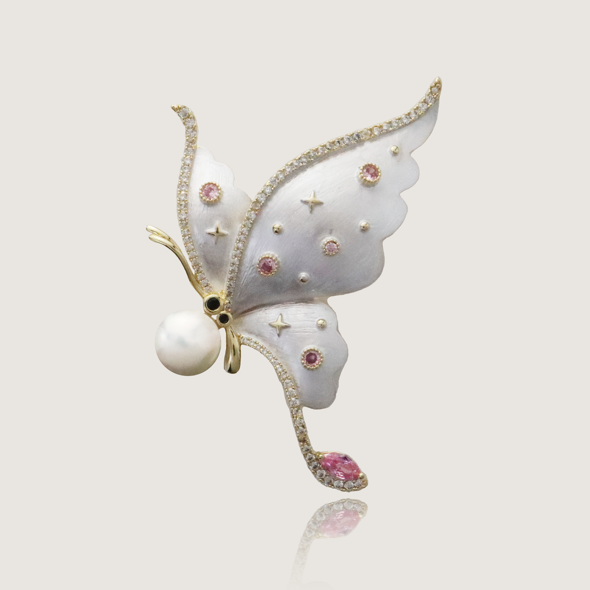 Ethereal butterfly brooch with delicate pink gemstones and a central pearl