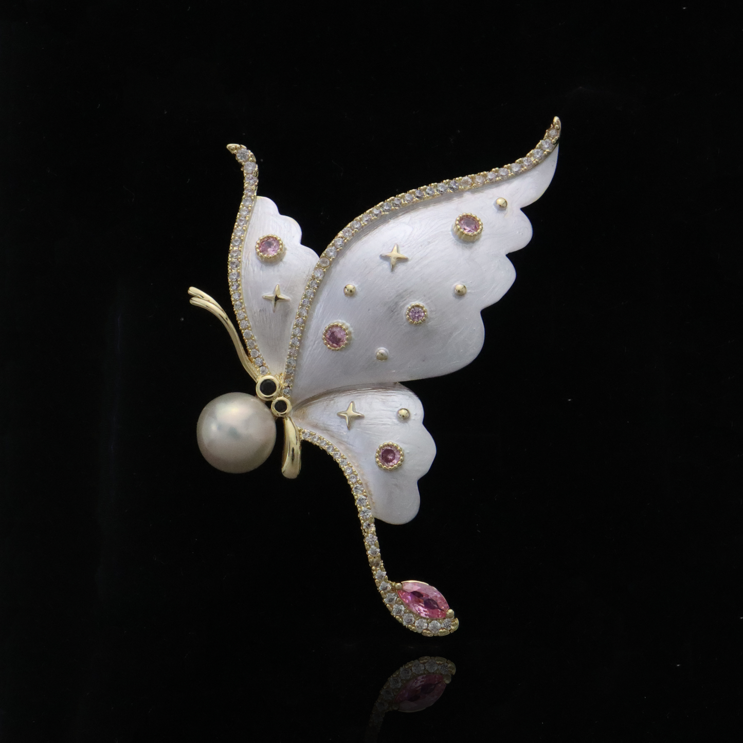 Enchanted gold-trimmed butterfly pin with pearl and starry gemstone details