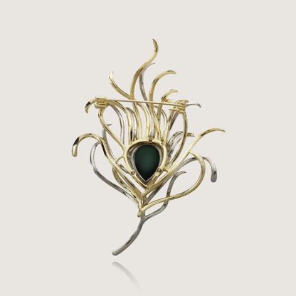 Extravagant gold and diamond feather-shaped brooch with an emerald-hued centerpiece