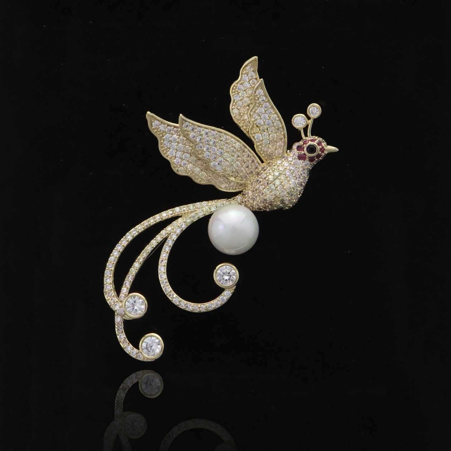 Luxurious avian pin with pavé crystals and pearl body, accented with a ruby eye