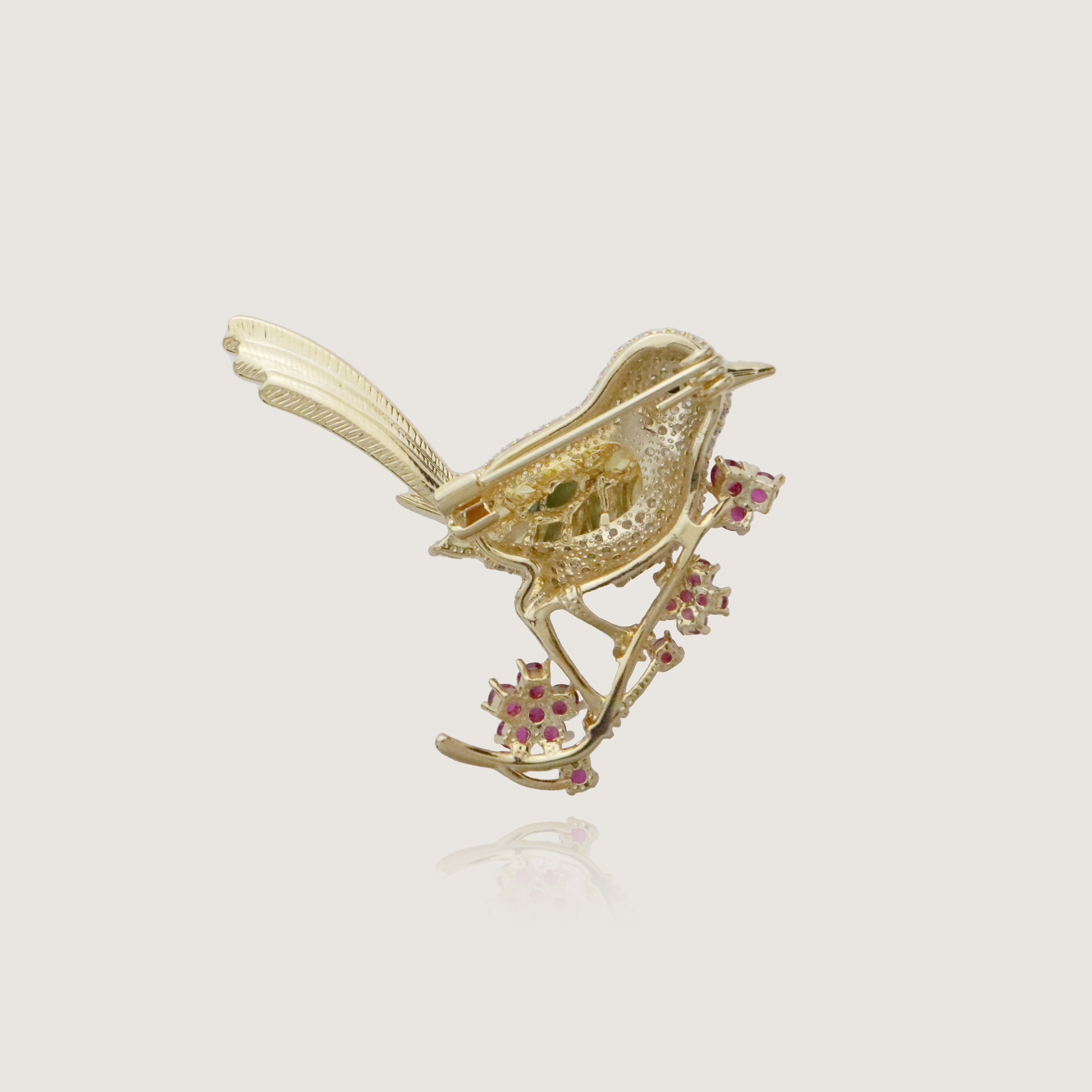 Radiant songbird brooch with sparkling gems and floral ruby embellishments