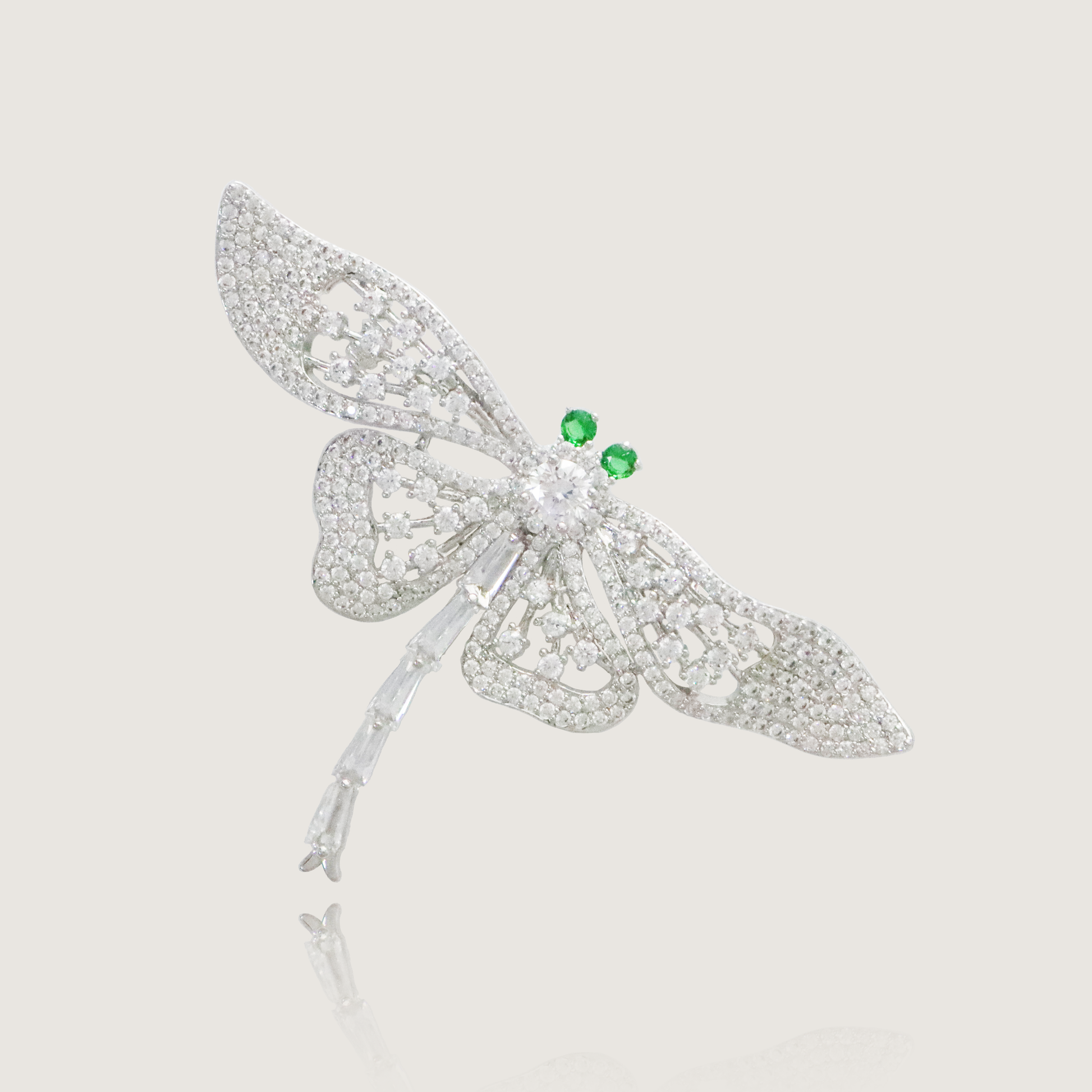 Sparkling dragonfly brooch with crystal wings and vibrant green gemstone eyes