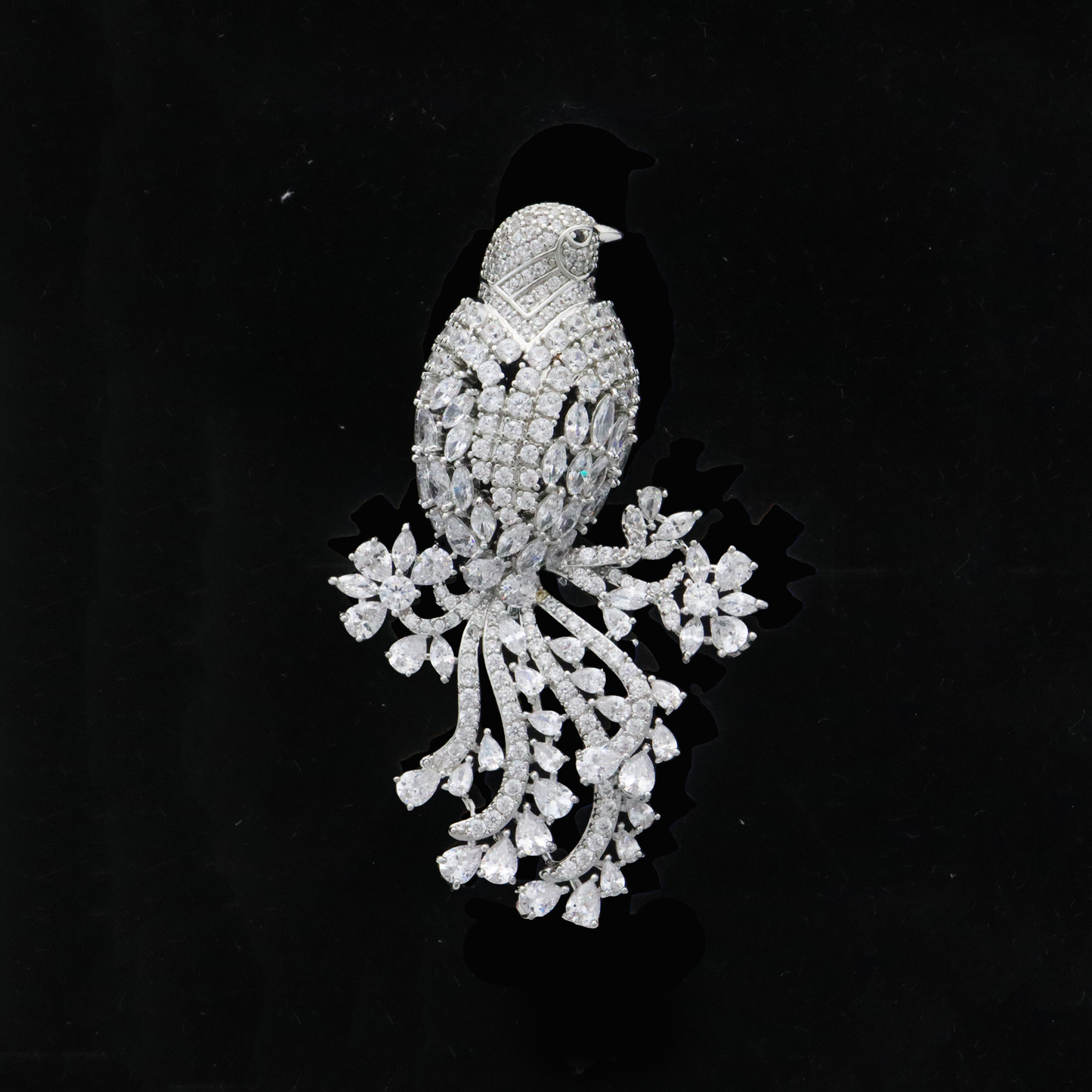 Chic avian pin with icy crystal plumage and a luxurious tail display.