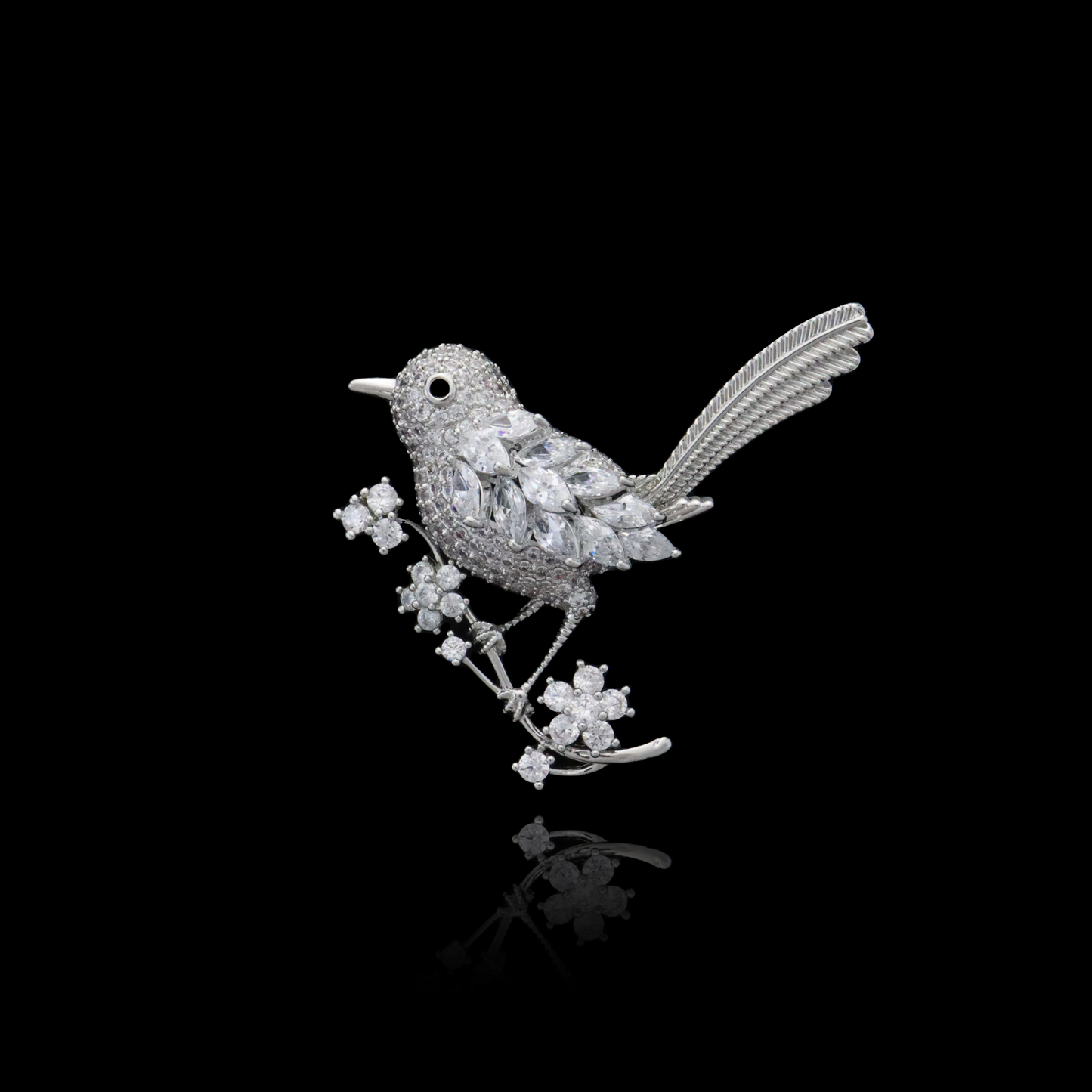 Sparkling diamond bird brooch perched on a silver branch