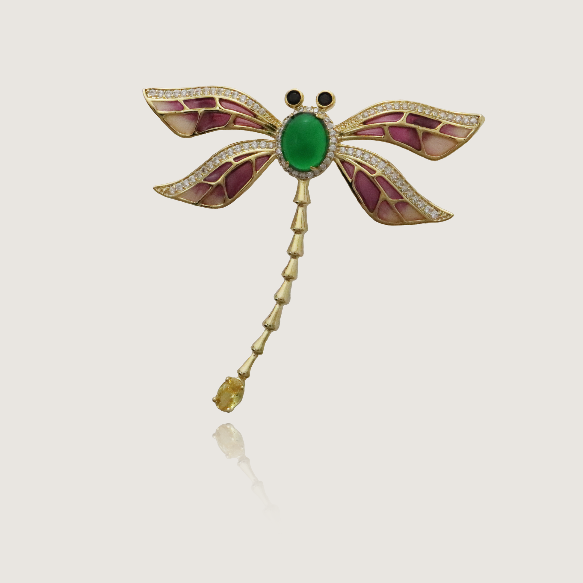 Vintage-inspired dragonfly brooch with jeweled wings and emerald-like centerpiece