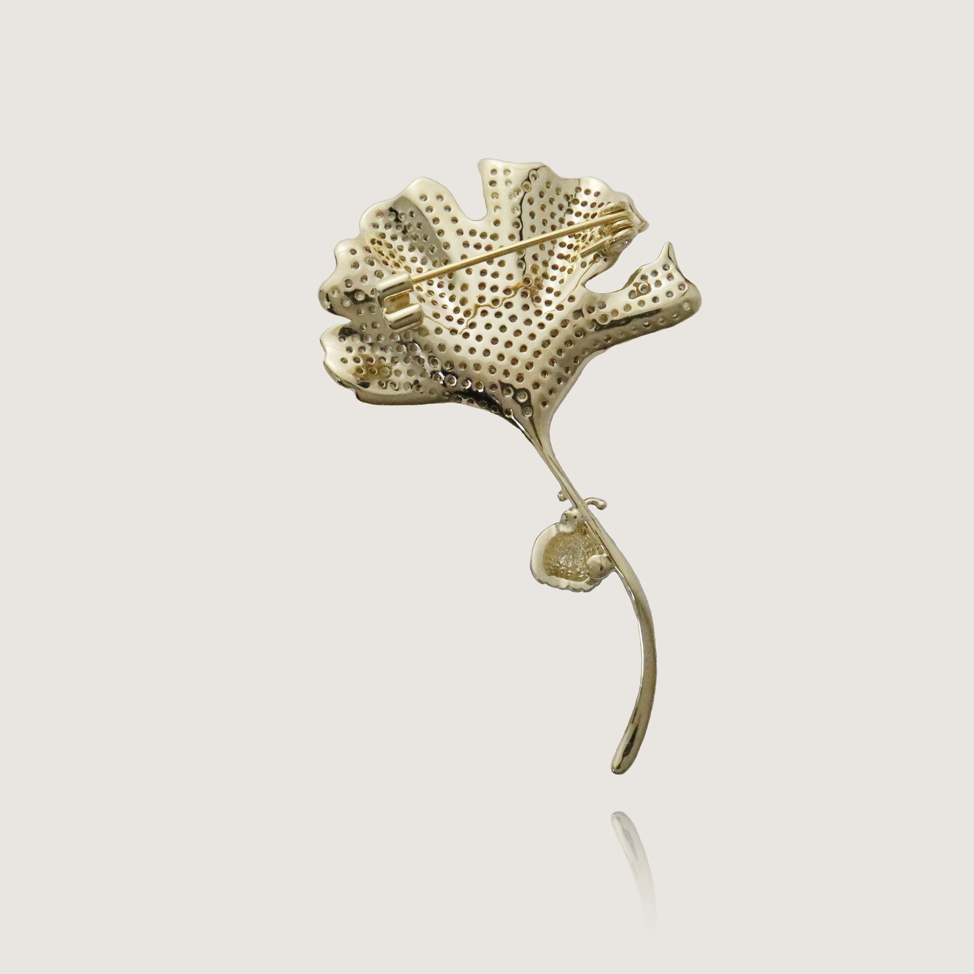 Whimsical ginkgo leaf pin with glittering diamonds and a delicate ladybug ornament